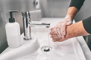 Man washing his hands.