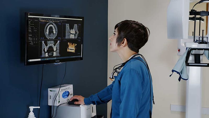 Dr. Govani using scanning dental technology.