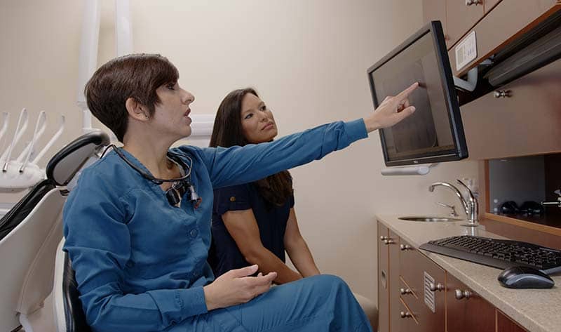 dentist looking at x-ray with a patient.