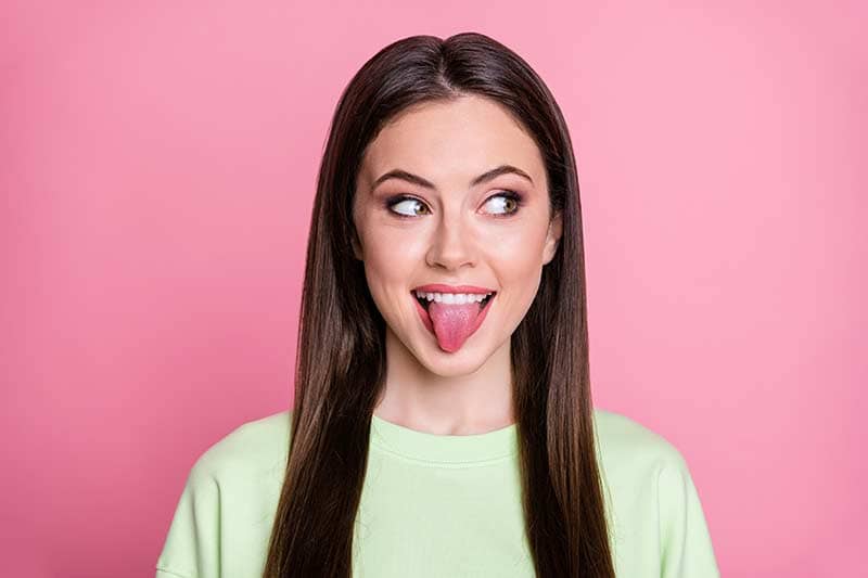Young woman doing Myofunctional Therapy tongue exercises.